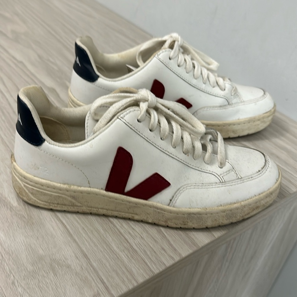 White vejas with red v and navy heel